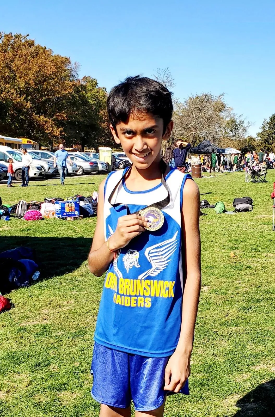 A younger Anish holding a medal in a North Brunswick Raiders singlet
