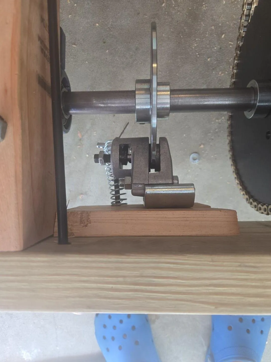 Close-up of brake caliper and disc on the rear axle beside the chain sprocket
