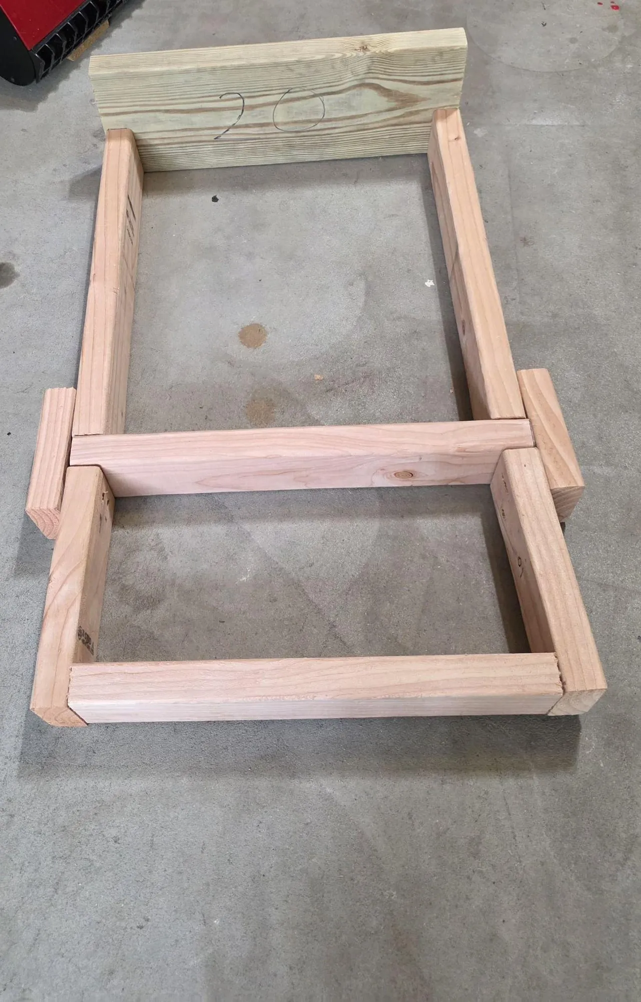 Small wooden rear frame dry-fitted on a garage floor