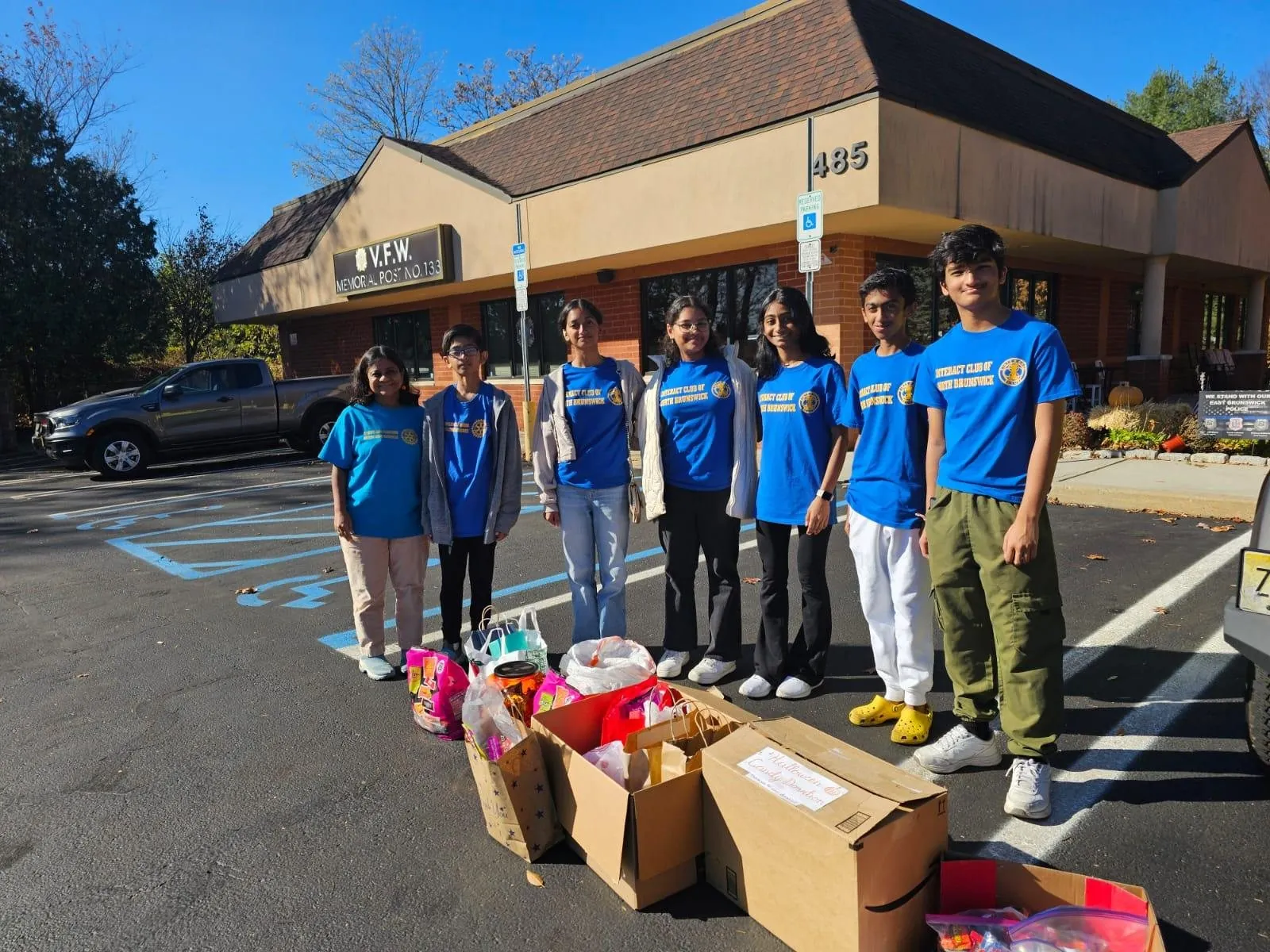 Club members outside a VFW post with boxes of donations